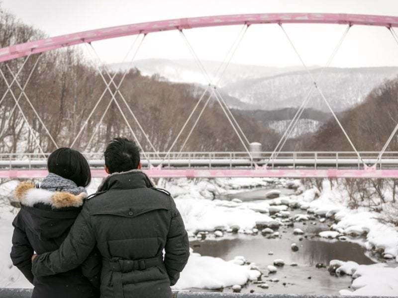 Admiring the river on their Niseko engagement